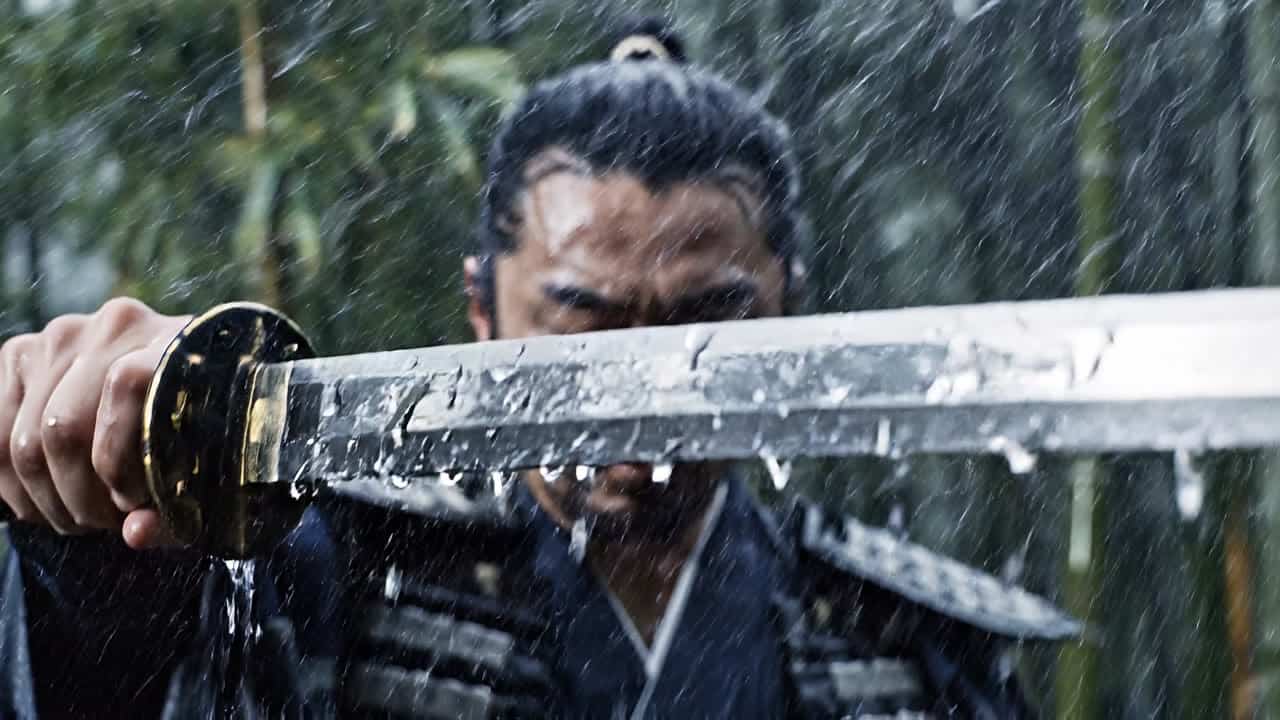 Google Veo 3.1 AI video example: A calm samurai stands alone in a bamboo forest during a storm, holding his katana lowered at his side. R...