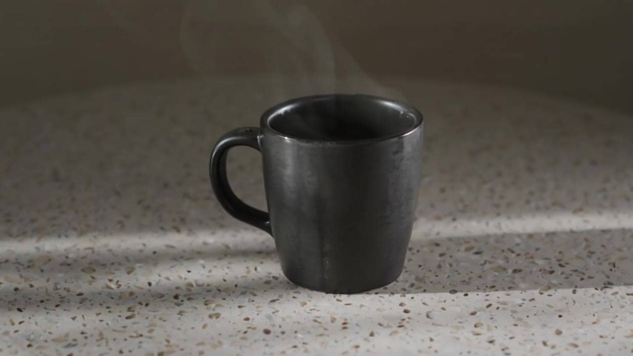 Luma Ray 3.2 a quiet cinematic product shot of a matte black espresso...