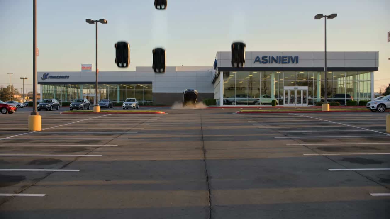 Kling 3 Pro AI video example: Locked-off wide exterior establishing shot of a large American car dealership, cinematic and realistic, 16...