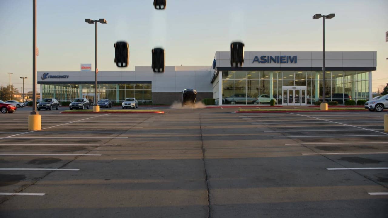 Kling 3 Pro AI video example: Locked-off wide exterior establishing shot of a large American car dealership, cinematic and realistic, 16...