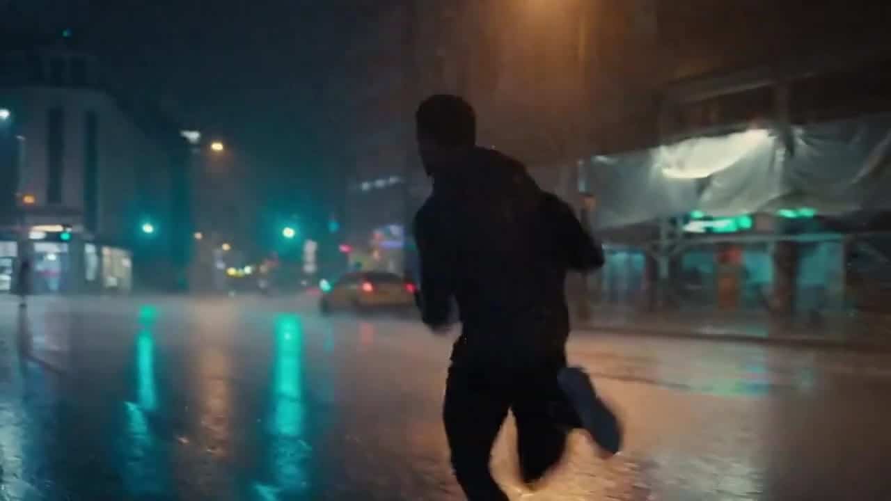 OpenAI Sora 2 AI video example: Wide 16:9 cinematic action shot, a runner sprints through a rainy city street at night, water splashes re...