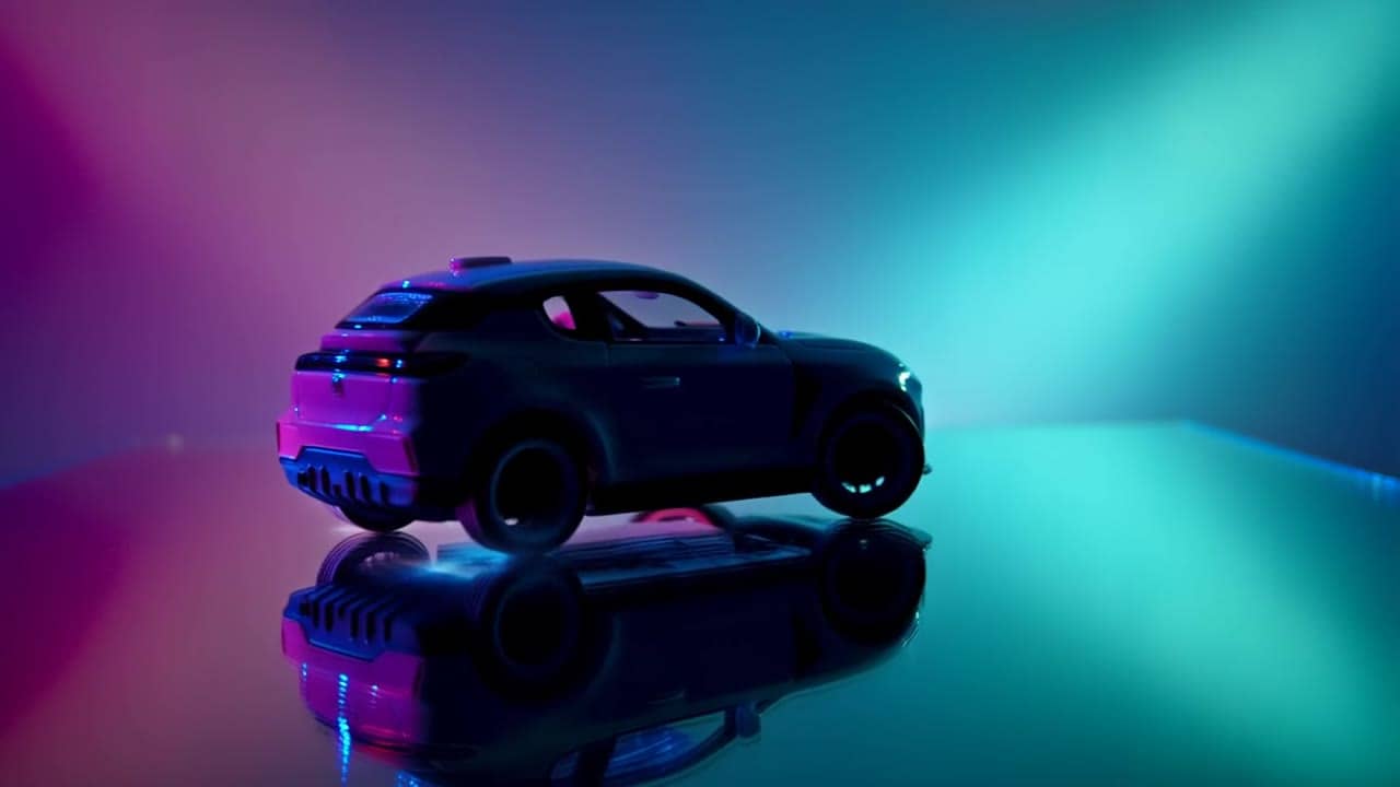 MiniMax Hailuo 02 Standard (Text to Video) AI video example: A toy car drifting in slow motion on a mirror table; tiny smoke, cyan/magent...