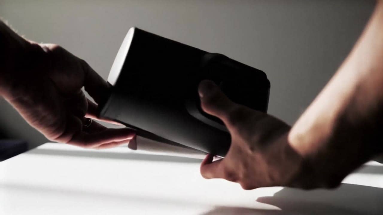 LTX Video 2.0 Fast AI video example: Product demo video on a clean tabletop, two human hands unbox a matte black coffee grinder, rotate i...