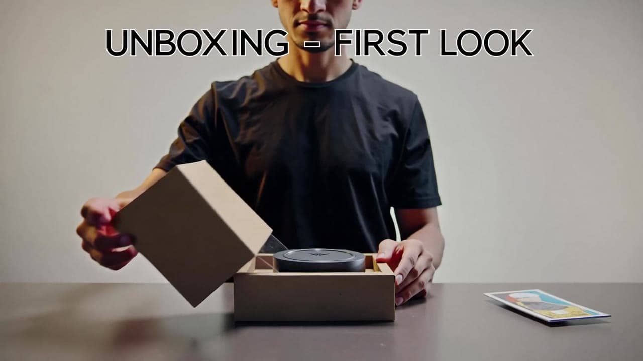 LTX 2.3 Pro AI video example: Wide 16:9 full-body unboxing video in a clean studio/kitchen setting. A person is fully visible (head-to-to...