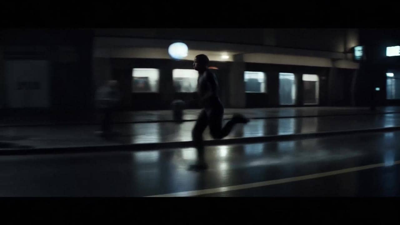 Ejemplo de video IA de LTX 2.3 Fast: Wide 16:9 cinematic action shot, a runner sprints through a rainy city street at night, water splash...