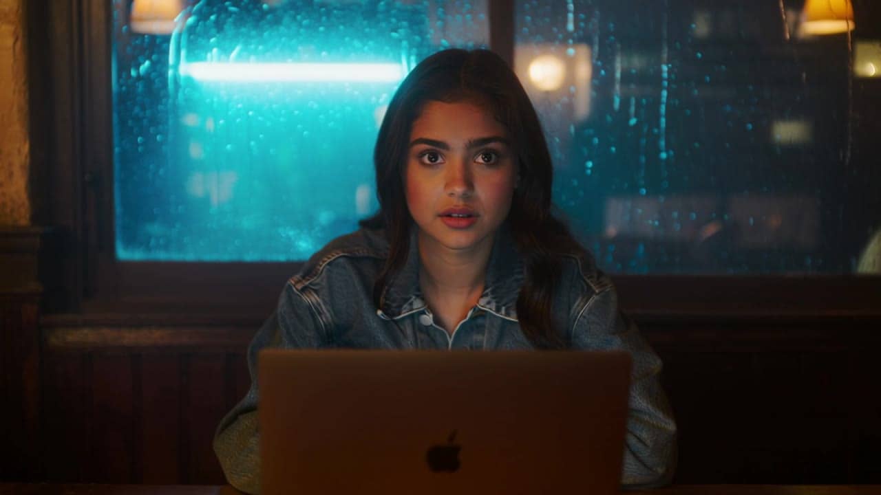 MaxVideoAI Kling 2.6 Pro example – 8-second 9:16 cinematic shot in a cozy coffee shop at night. A young woman in a denim jacket sits by the window,…