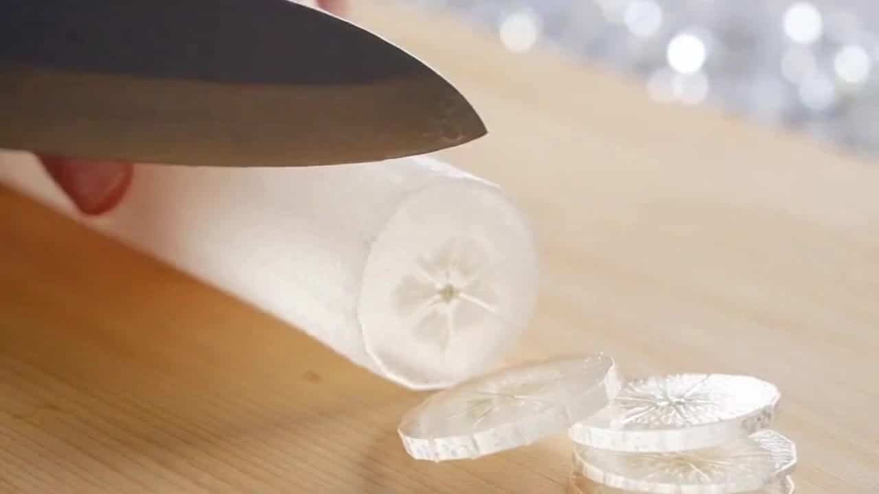 OpenAI Sora 2 AI video example: Generate an ASMR video. The task is to slice a banana into thin slices with a knife. The banana has a gla...